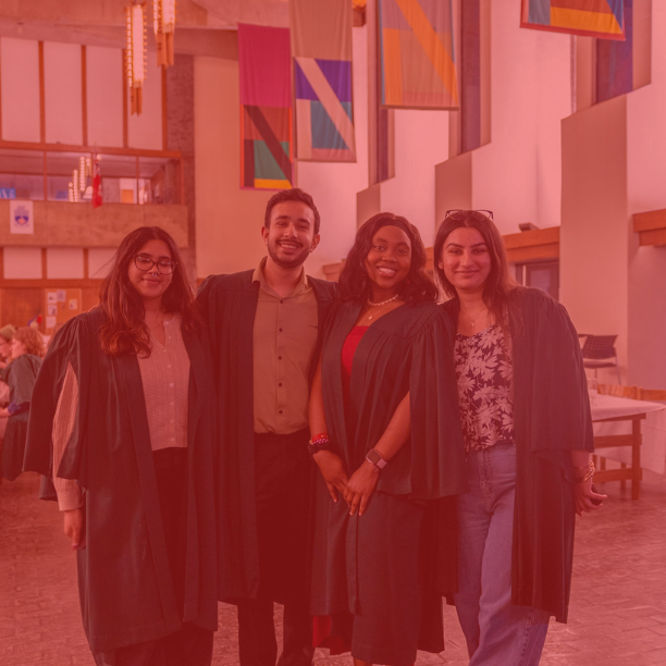 Photo of five students wearing green robes