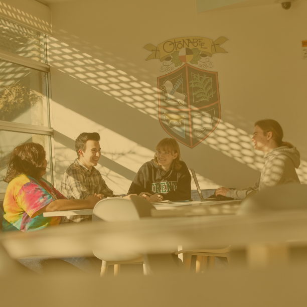Photo of four students sitting at table