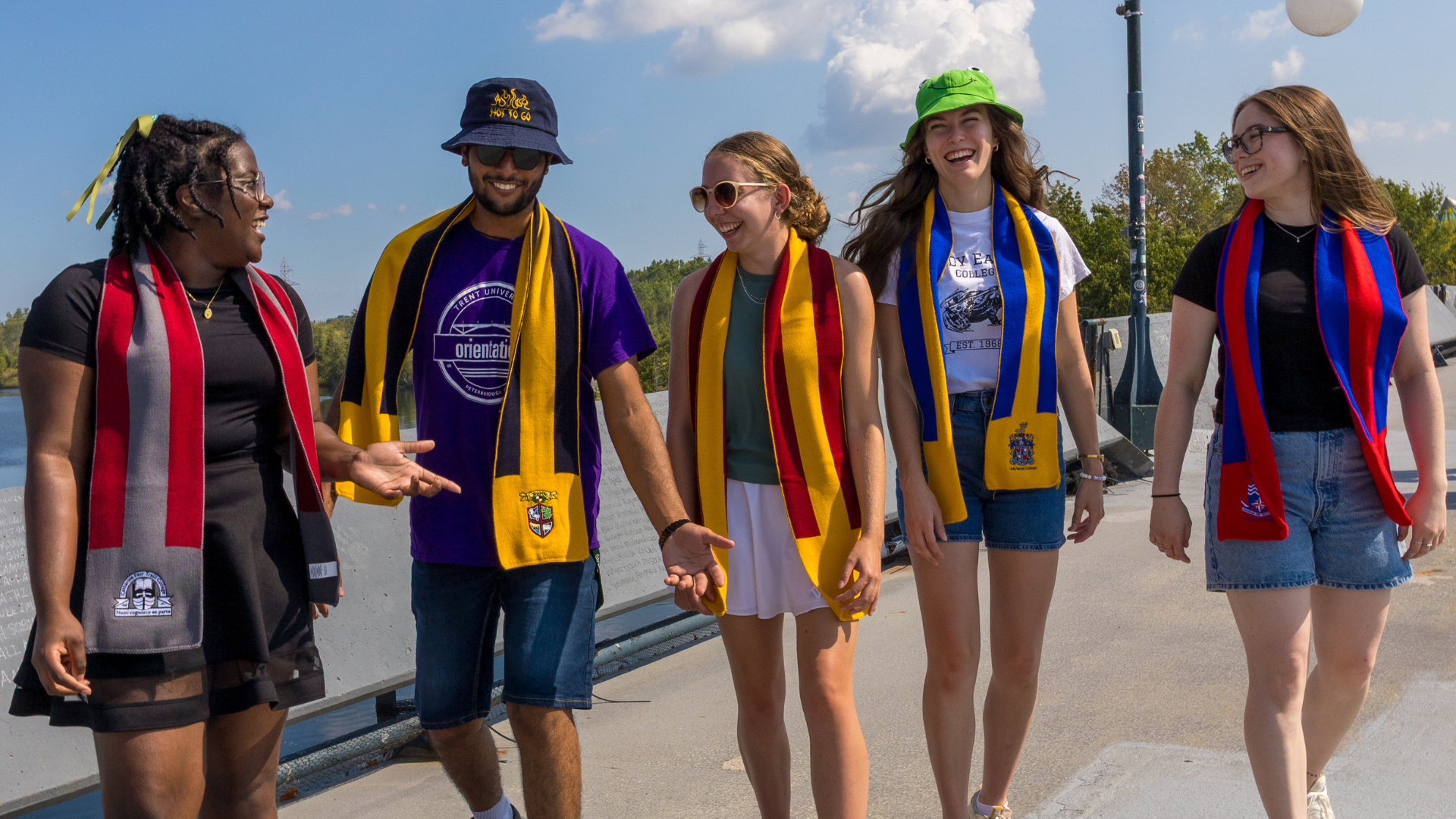 Photo of five students wearing different coloured scarves