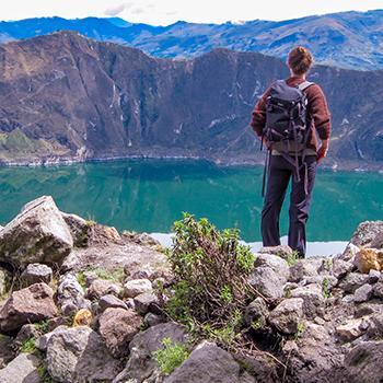 A hiker standing on a mountain