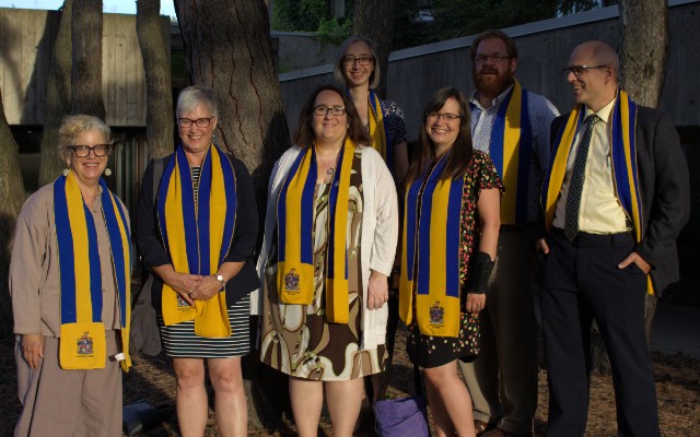 A group of Lady Eaton College fellows wearing their yellow and blue scarves.