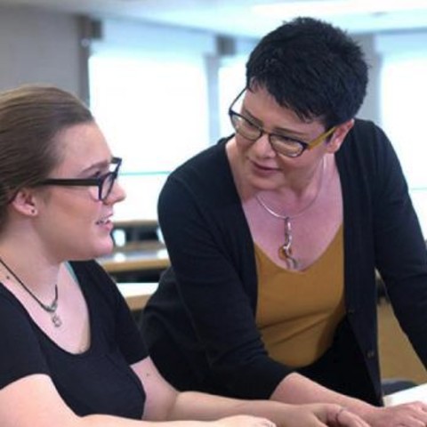 A student talking with a teacher
