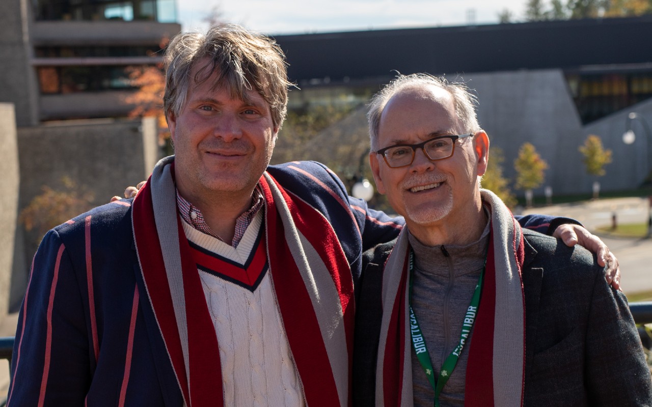 Two Traill Professors wearing their college scarves
