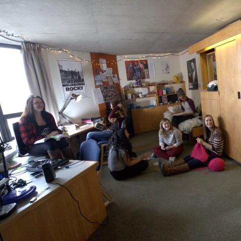 Three students studying in a Lady Eaton residence room.