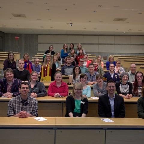 A classroom gathered for a group shot after a lecture at Gzowski College