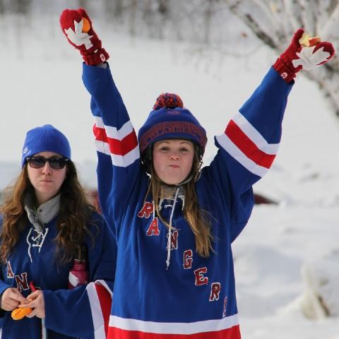 A woman celebrating a broomball goal at Champlain College