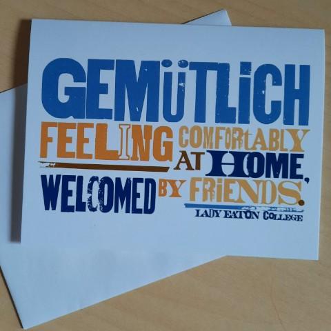 A Lady Eaton College Card reading "Gemutlich: Feeling Comfortably at Home, Welcomed by Friends"