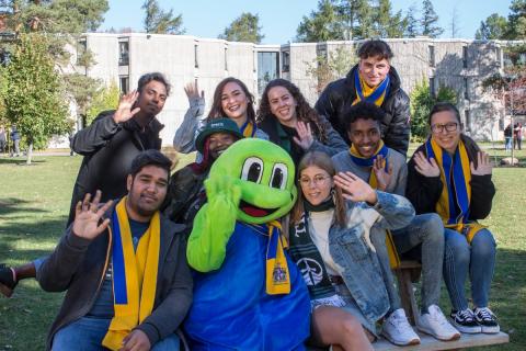 A group of students posing with the Lady Eaton Toad mascot
