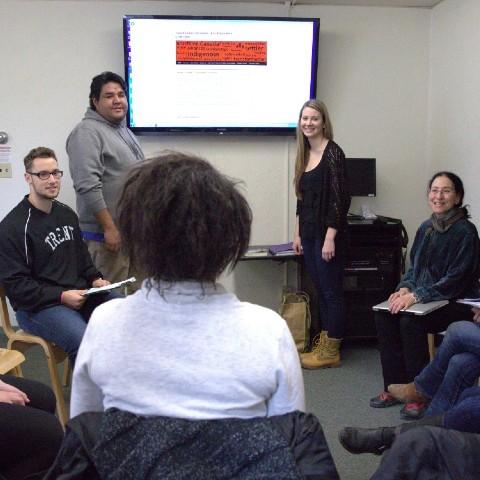 Students having a discussion in a classroom at Champlain College