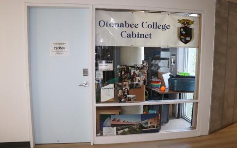 Outside the Otonabee College Cabinet office, looking in through the large window.