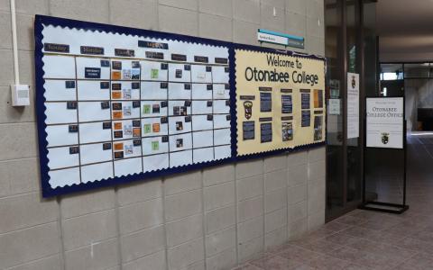 The hallway outside the Otonabee College office, featuring a calendar of events and information for students.