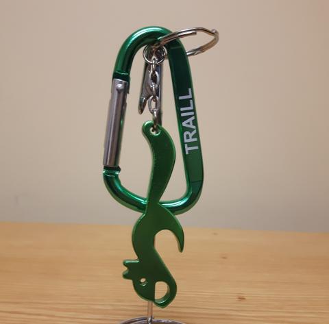 A green and silver carabiner with a matching, squirrel-shaped bottle opener attached.