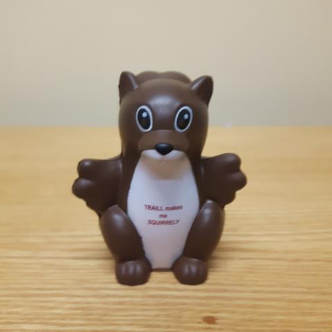 A brown foam squirrel with a white belly. On the belly are the words, "Traill makes me squirrely" in maroon.