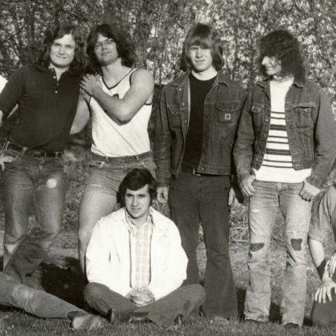 A black and white photo from the 1970s of several Traill Students posing and smiling for the camera.