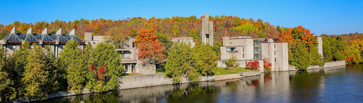 Exterior view of Champlain college buildings in amongst the fall trees on a sunny fall afternoon