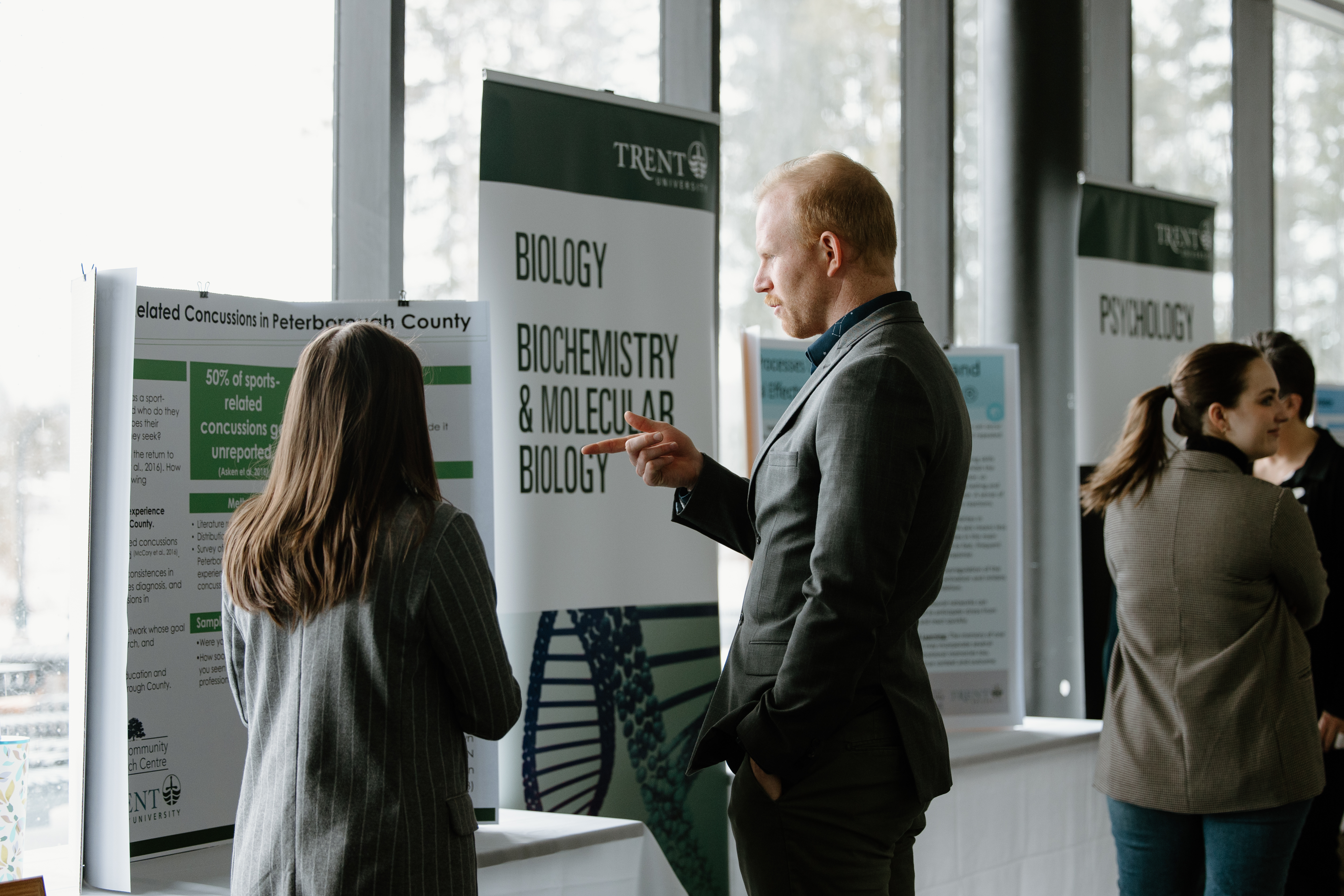 researcher explaining project to person standing