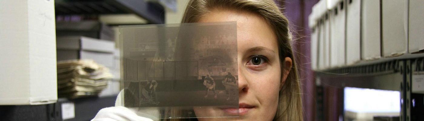 Student holding up a photo negative as part of a community-based research project.