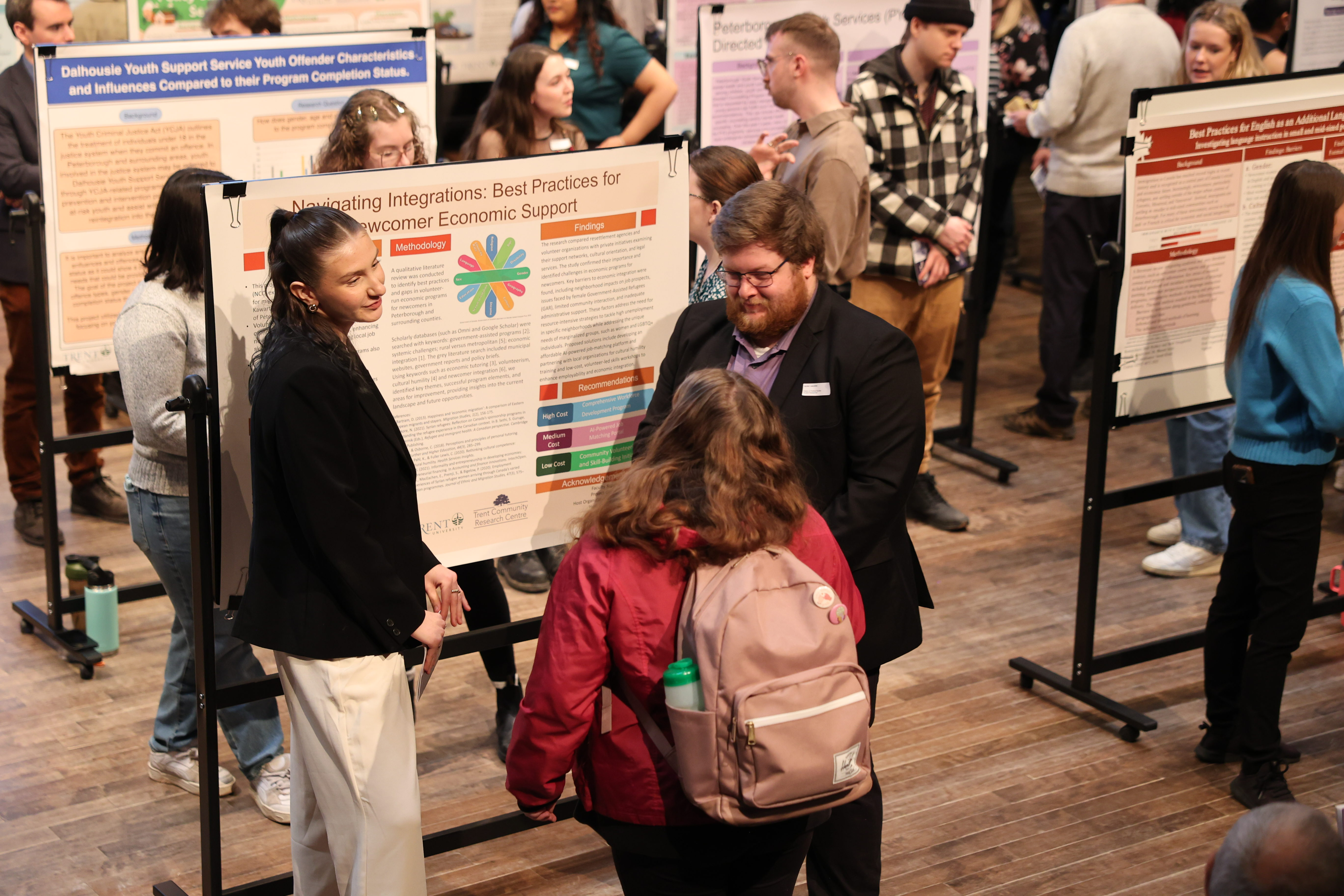 group of students around research poster