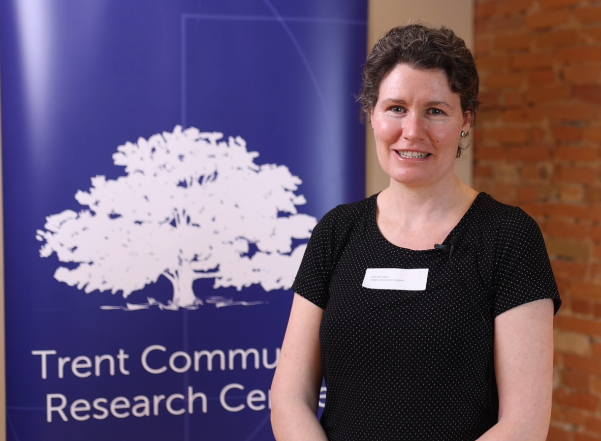 Woman standing in front of TCRC banner