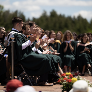 Graduates clapping during convocation.