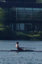 Brendan Edge rowing on the river with the Trent Athletics Centre in the background