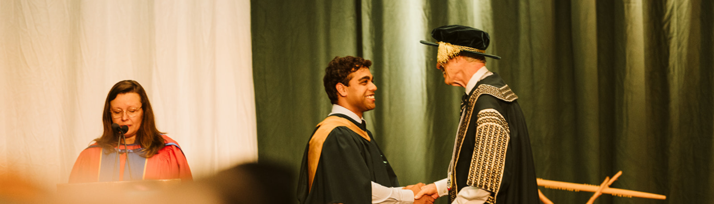 Student shaking hands on stage  