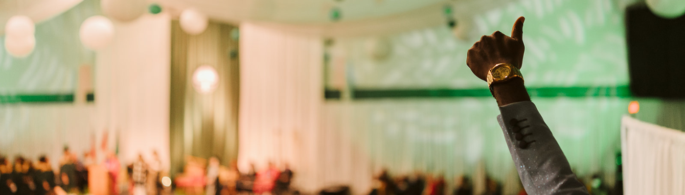 Someone cheering on graduate at convocation