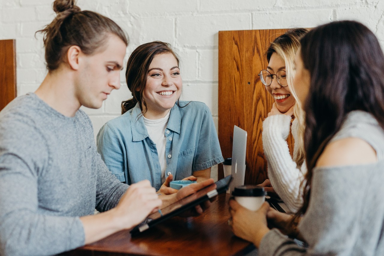 A group of friends at a coffee shop. Photo by Brooke Cagle on Unsplash