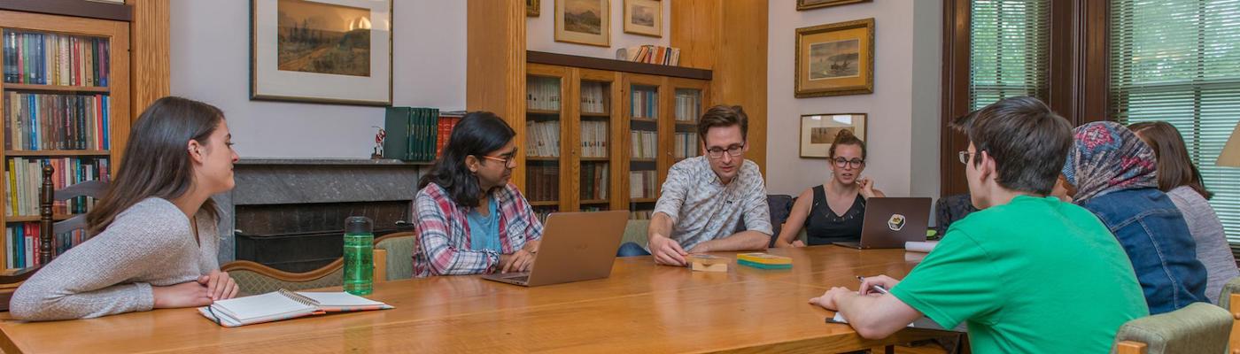 Students sitting with faculty at Traill College