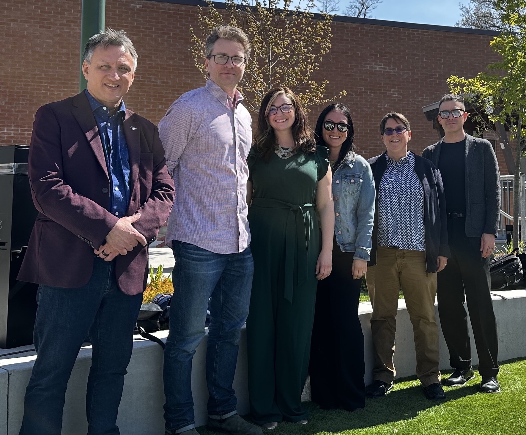 image of students and faculty standing outside smiling at the camera