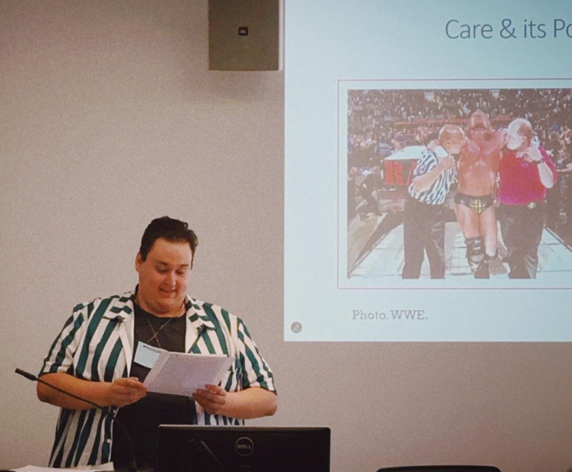 Tyler Majer standing at a podium during a presentation