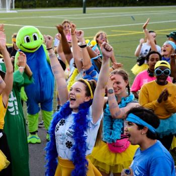 Orientation Leader in Lady Eaton College attire celebrating at Justin Chiu Stadium.