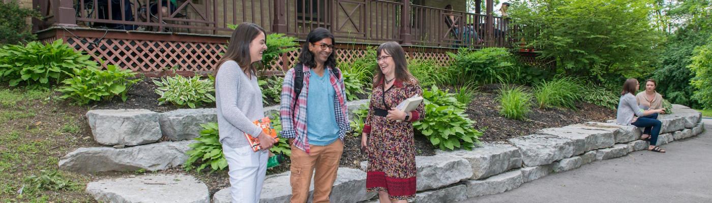 Student chatting with on another at Traill College 