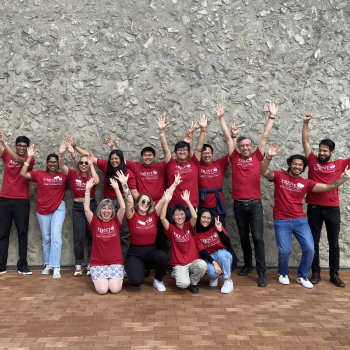 Group photo of Trent International Team wearing their red orientation t-shirts and standing outside Champlain College