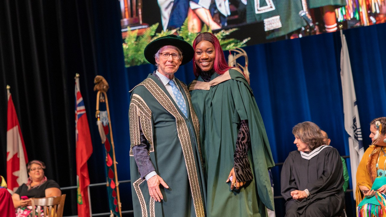 A graduting student with Chancellor Stephen Stohn