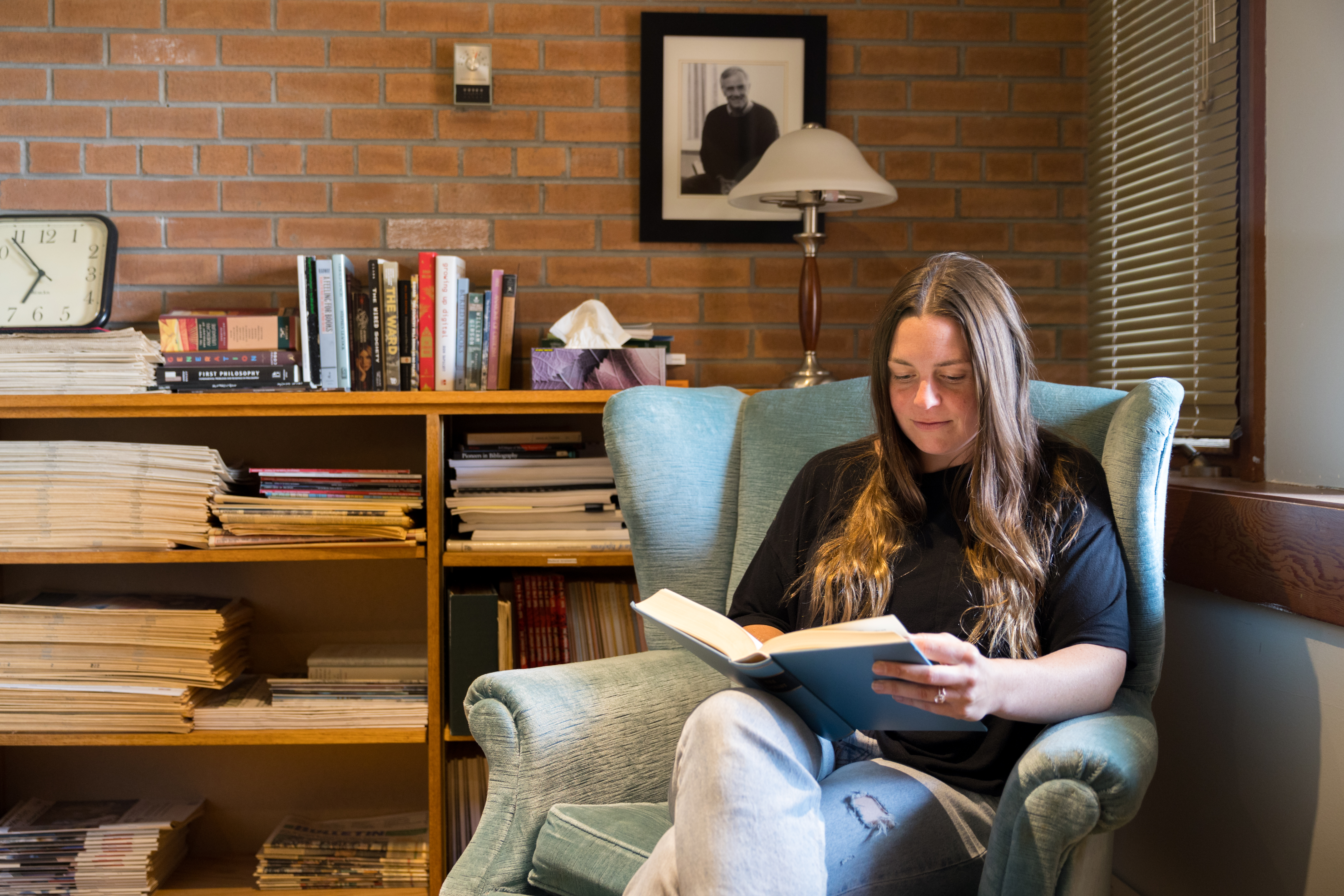 Student reading a book on campus.