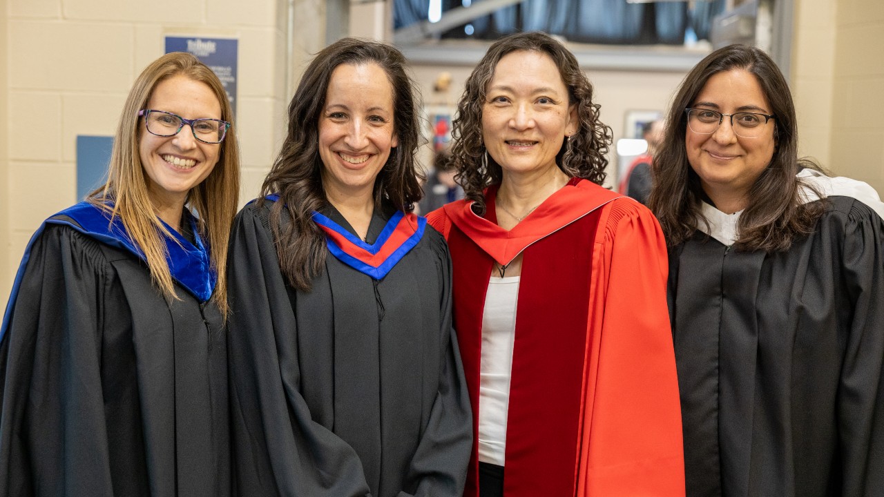 A professor and students at Convocation