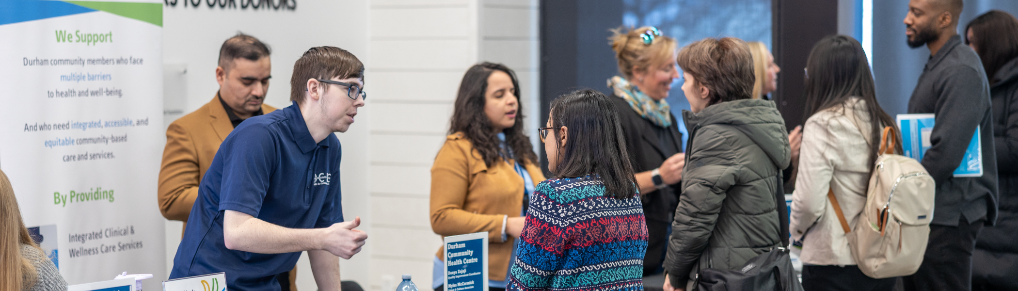 Students talking with people at a health event