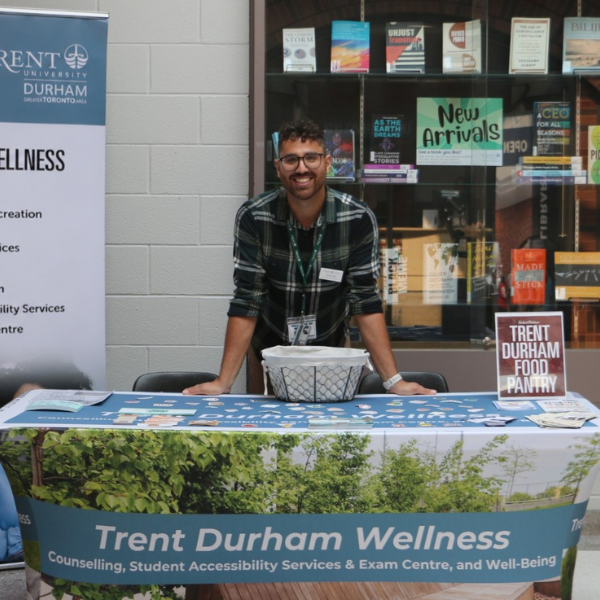A man stands at a booth during a health fair