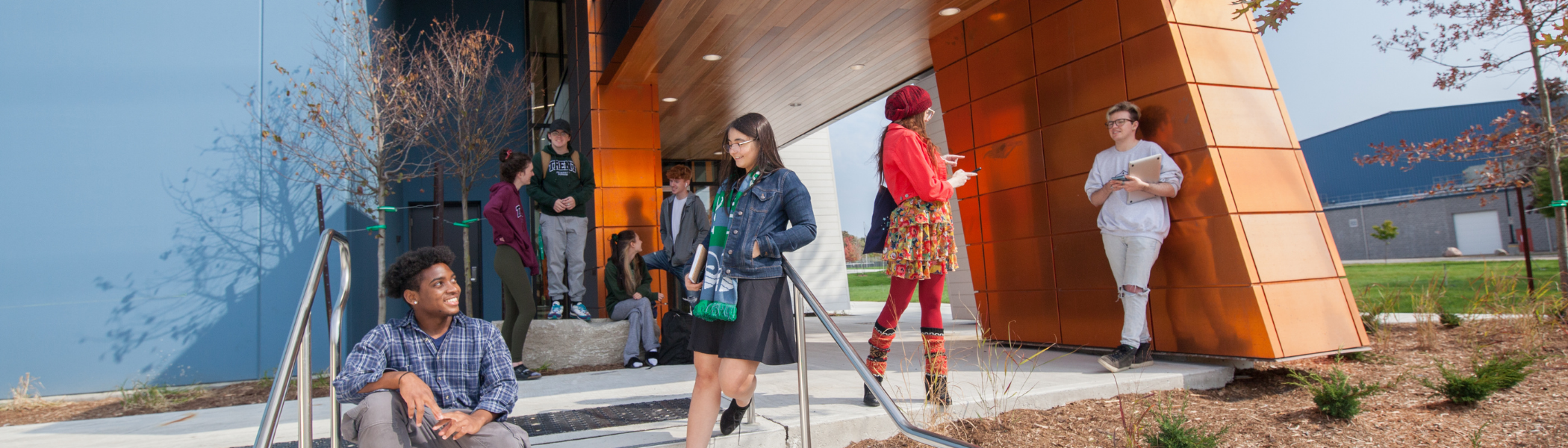 Students at Trent Durham campus hang outside steps