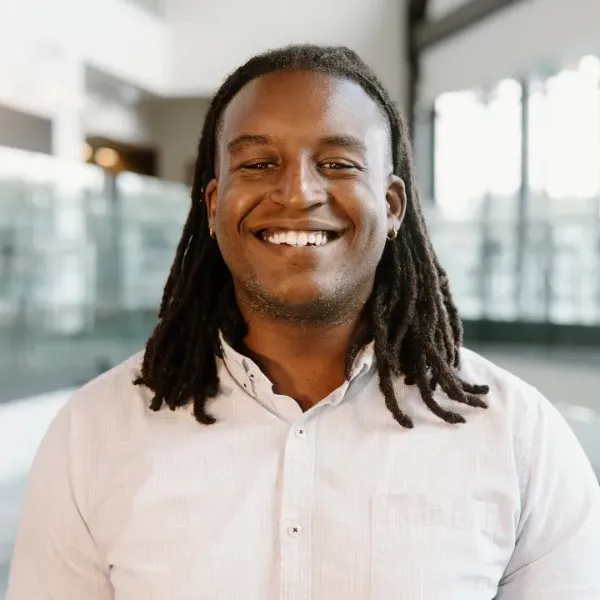 A man faces the camera smiling