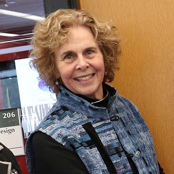 Deborah Berrill smiling in front of Design Studio in Bata Library