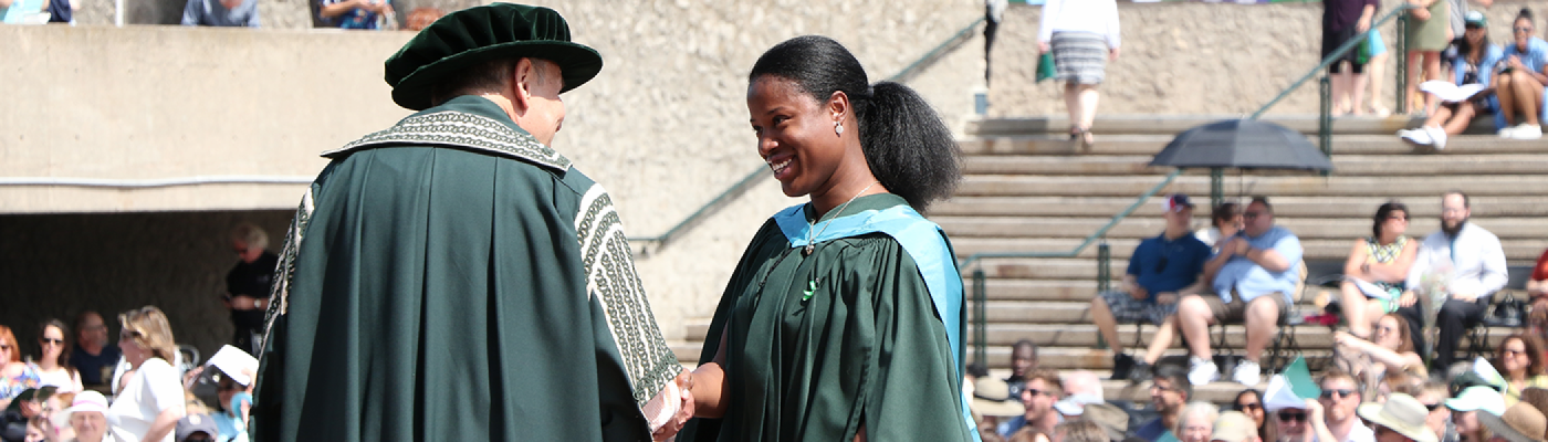 Graduate receiving diploma during convocation