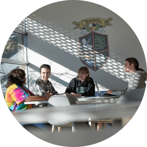 Four students hanging out in a common room