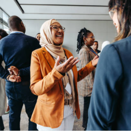 A conference room with people engaging in conversation