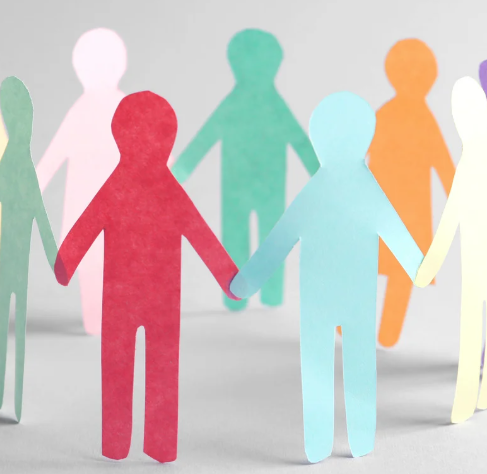 Image of cut-out paper people holding hands