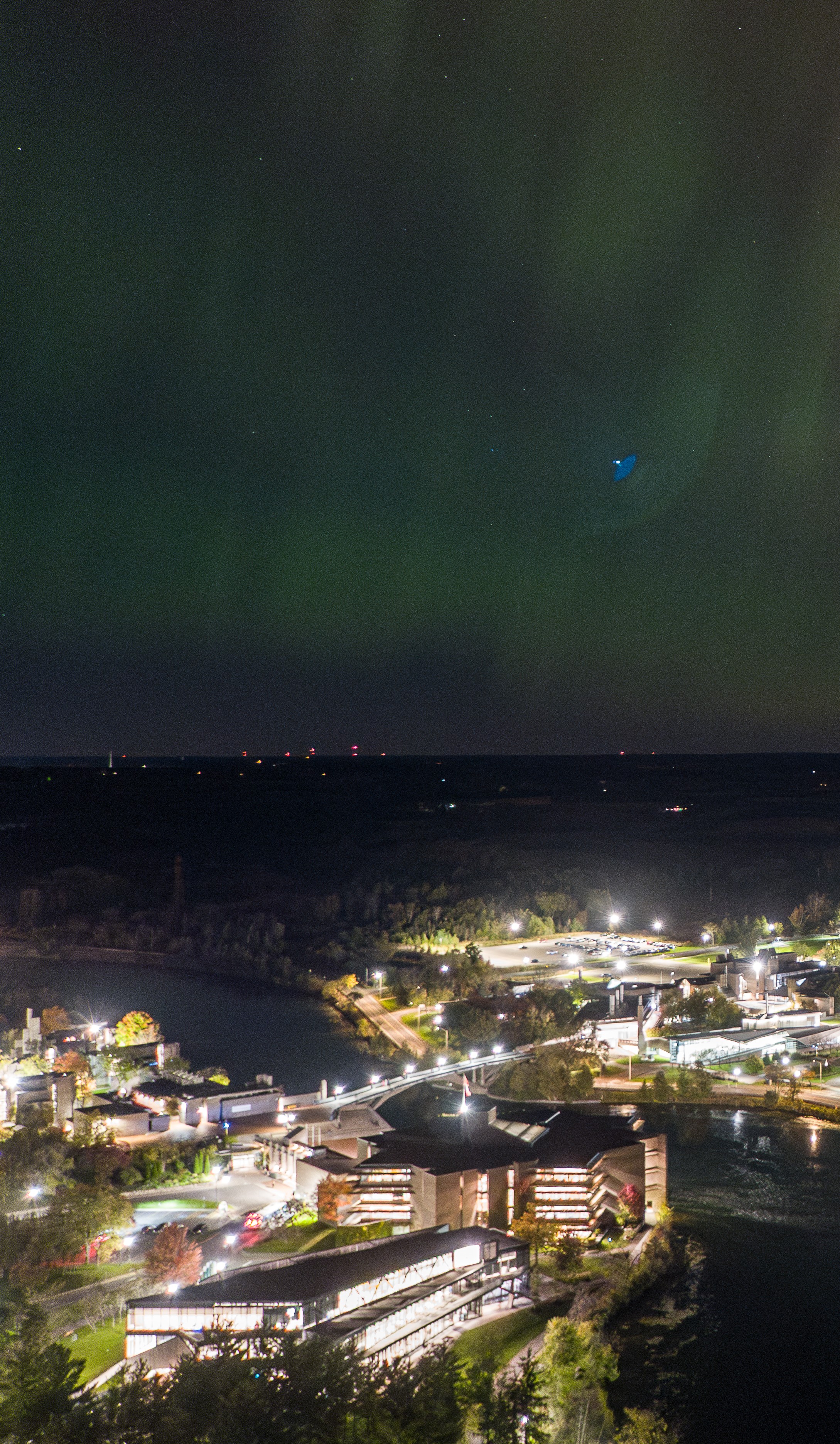 Aerial photo of the campus with the northern lights in the sky