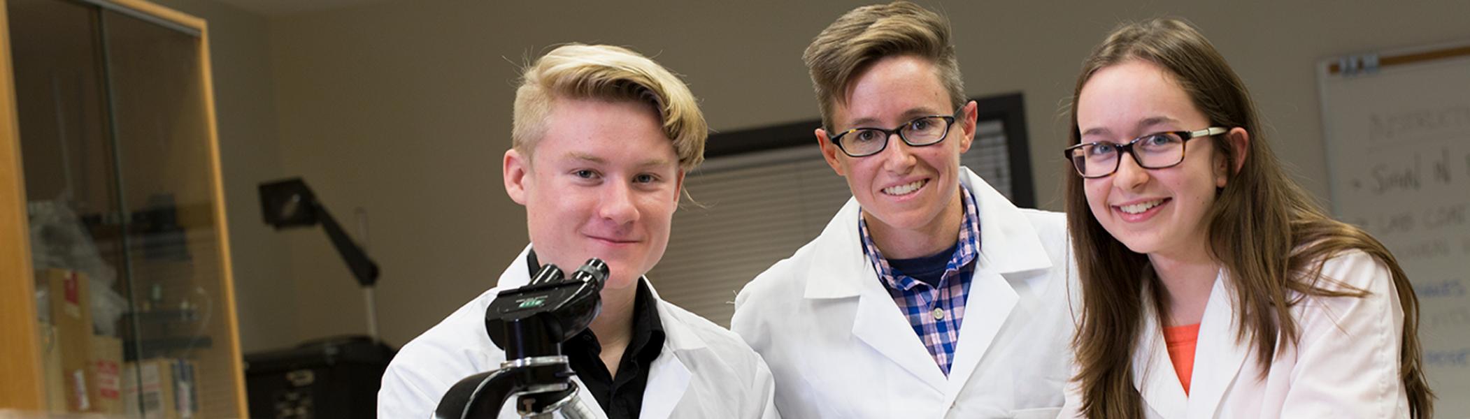 Professor with students in a chemistry lab.