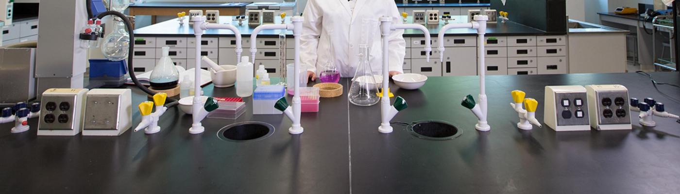 Chemistry lab equipment across a bench.