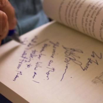 an open book being autographed